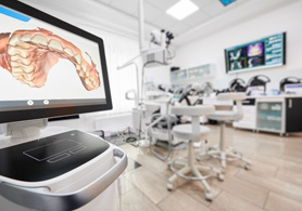 a monitor showing a digital impression of a mouth in an empty dental treatment room