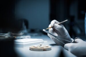 a dental lab technician crafting veneers