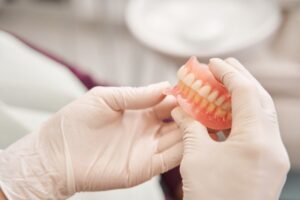 a dentist examining dentures